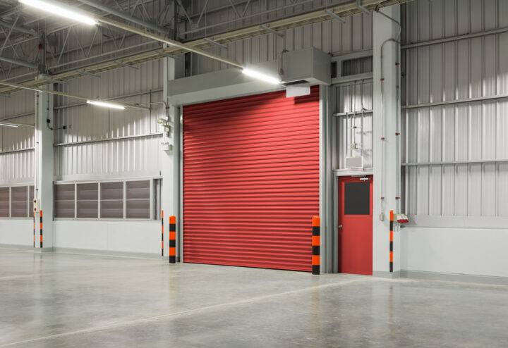 a red commercial garage door installed by Overhead Door Companies in Green Bay